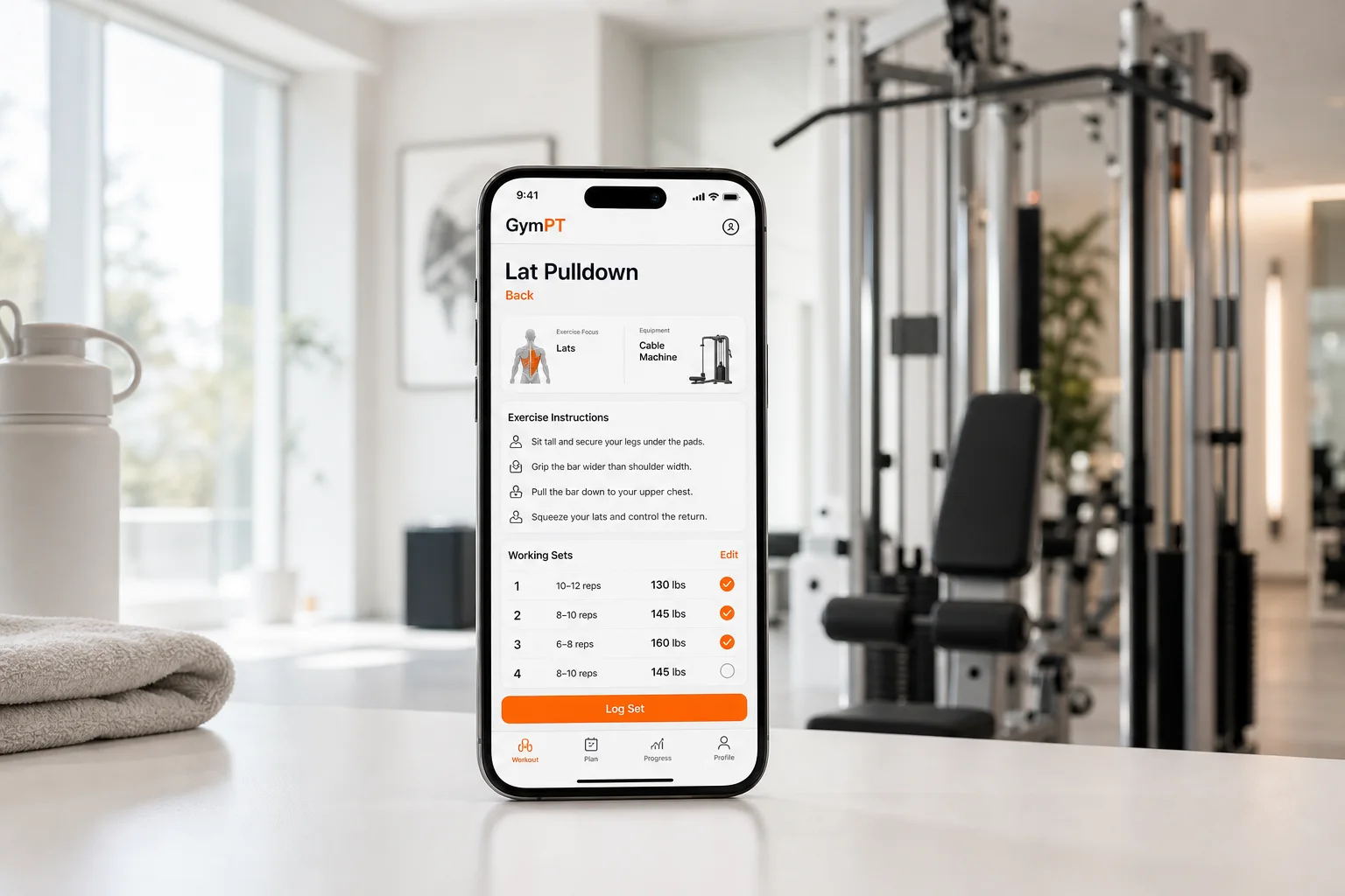 GymPT workout plan on a phone beside a lat pulldown machine