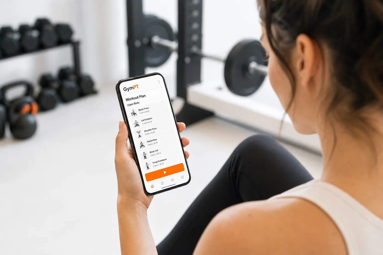 Débutant consultant un plan d’entraînement GymPT sur son smartphone dans une salle lumineuse