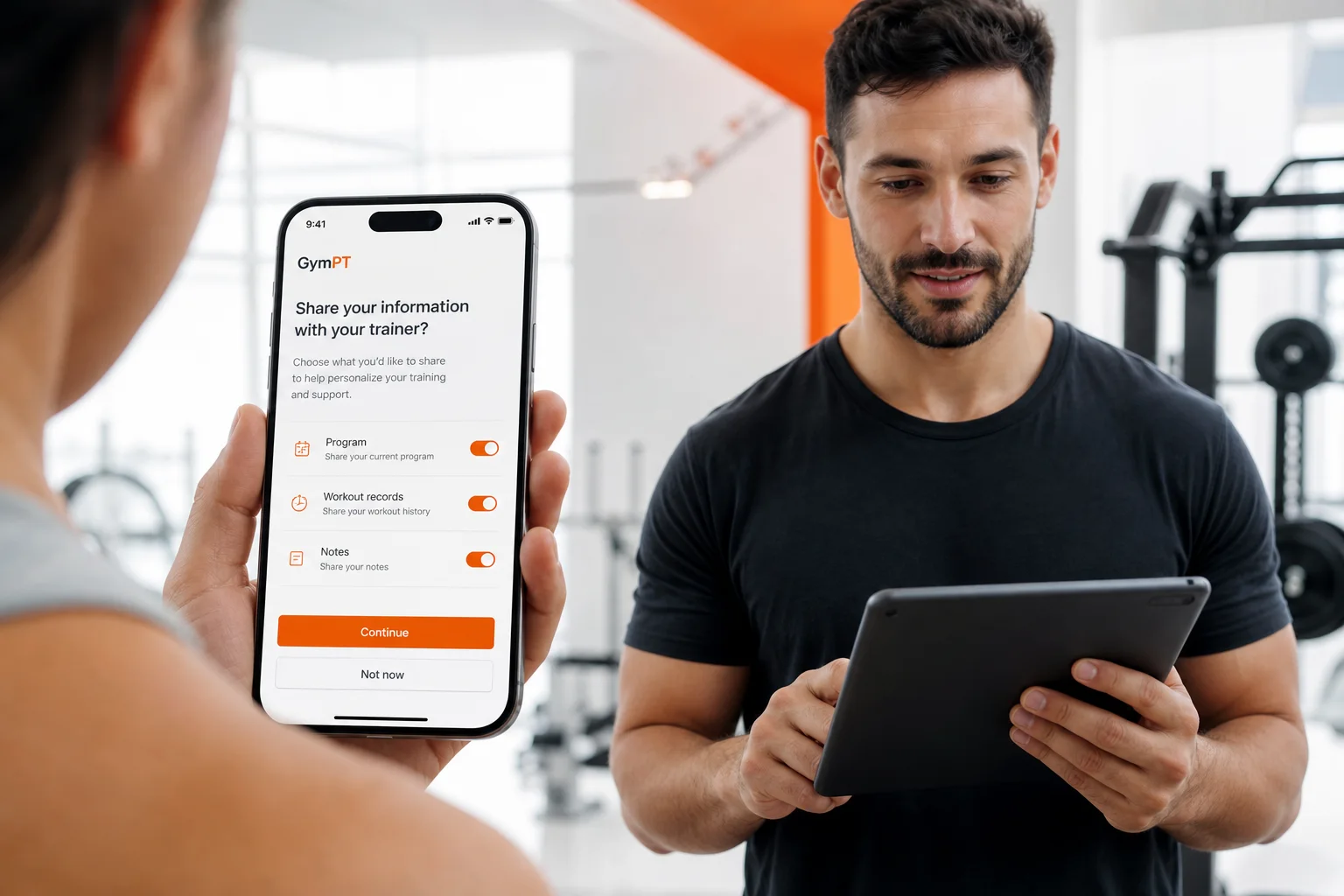 Gym member reviewing selective training-data permissions with a personal trainer in the GymPT app